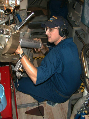 Figure 3: Navy Crewman &quot;Ted&quot; Groustra loads an XCTD for launching. Image courtesy of U.S. Navy Arctic Submarine Laboratory.