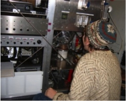 Brooks working with custom-built ice nucleation instrument inside Convair 580. Image courtesy of Sarah Brooks.