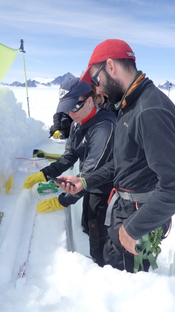 JIRP faculty member Dr. Natalie Kehrwald (USGS) and student Chris Miele measure and sample a snow core for biogeochemical analysis. Photo courtesy of Shad O&#39;Neel.