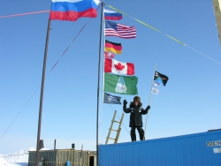 Tim Martin poses with expedition flags and school flags at Camp El&#39;gygytgyn, Chukotka, Russia.