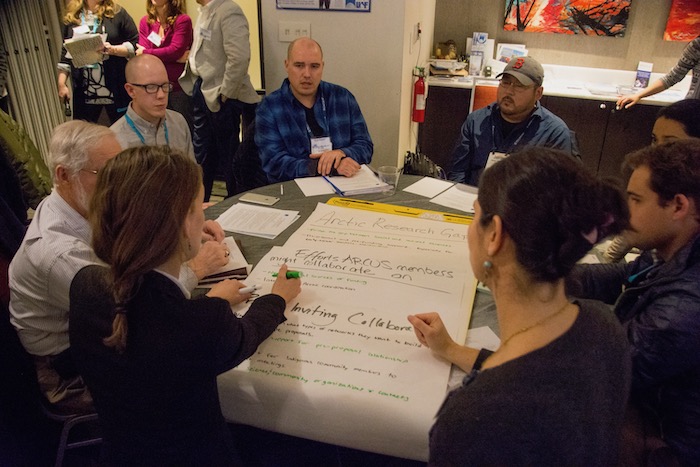 In separate table discussions, ARCUS community members shared ideas about how to identify Arctic research gaps and how best to collaborate. Photo courtesy of Joed Polly, ARCUS.