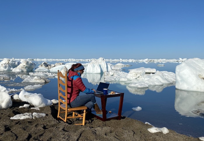 Figure 1. Principal Investigator Jessie Creamean prepares for a podcast interview in Utqiaġvik. Creamean&#39;s research is part of a multi-year effort to determine whether ice nucleating particles (INPs) from permafrost make their way into the Arctic atmosphere via lateral hydrologic transport. To do this, her team collects samples along coastal water, lakes, and the Elson Lagoon. Photo courtesy of Thomas Hill.