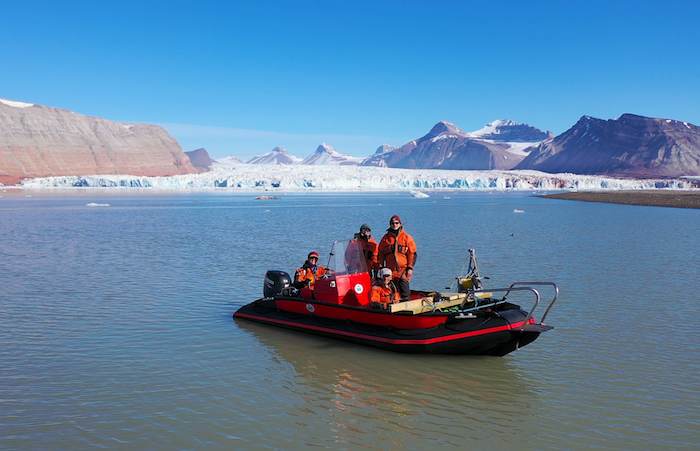 Figure 6. Our research team in front of the Kronebreen glacier in July 2021 (photo taken from drone). Photo courtesy of Mark Goldner.