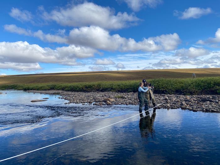 Figure 3. Cézanna Semnacher and Dave Wesolowski, SEDC Technicians, measuring stream discharge for the Arctic LTER research group along the Kuparuk River. Photo courtesy of Kela Vicich.