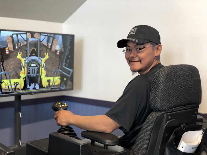 Photo 5. Student in Heavy Equipment training class working on virtual equipment utilized in partnership with NACTEC. Photo courtesy of Kawerak, Inc.