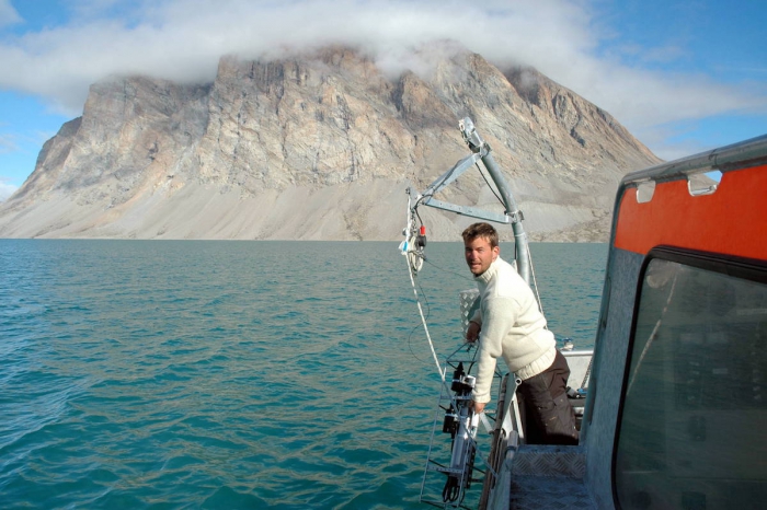 Marine biologist Mikael Sejr from Aarhus University measures temperature and salinity in Young Sound, Northeast Greenland, for the GEM database. Photo courtesy of Mikael Sejr.