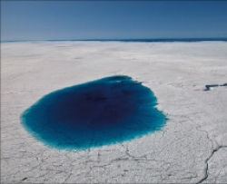 A supra-glacial melt lake on the Greenland Ice Sheet at ~950 m elevation. The lake is ~1.5 km wide and ~10 m deep. Photo courtesy of Ian Joughin.