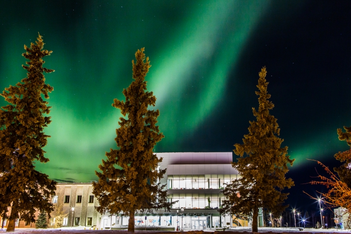 The aurora creates a dynamic display behind the University of Alaska (UAF) Murie Building on upper campus. UAF photo by JR Ancheta.