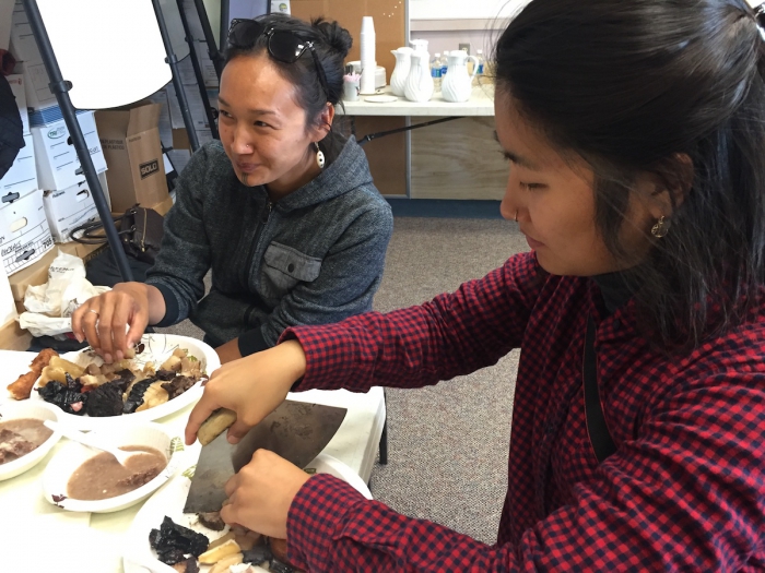 Project team members Charlene Apok and Sarah Huang enjoying a meal of traditional foods in Utqiaġvik, Alaska. Photo courtesy of Courtney Carothers.