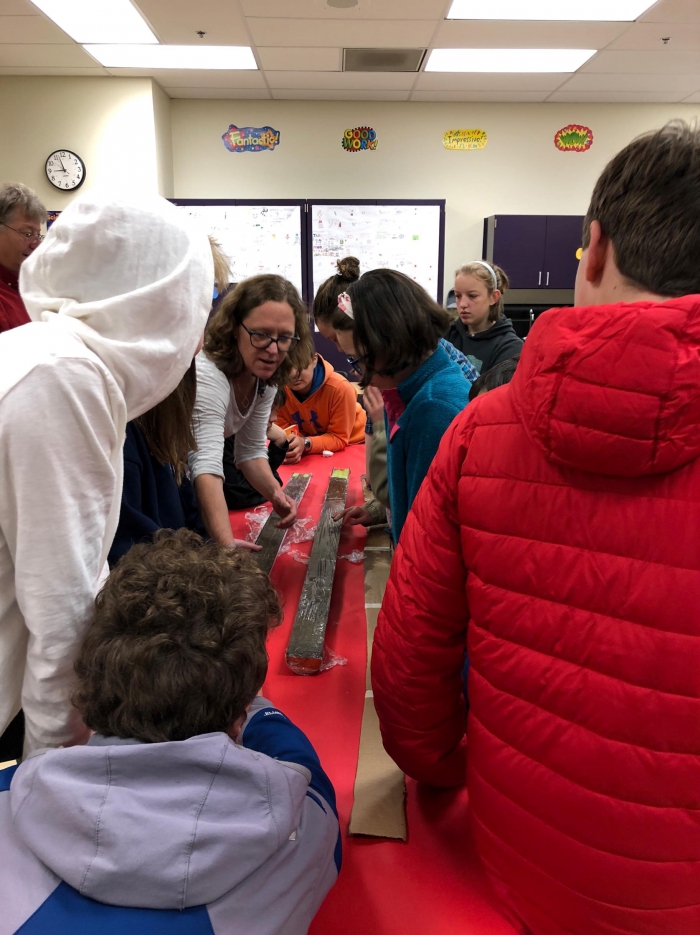 Scientist in Residency Fellow, Dr. Rachel Lauer, shows 7th grade students in Sitka, Alaska how she works with submarine cores. Photo courtesy of Kristina Tirman.