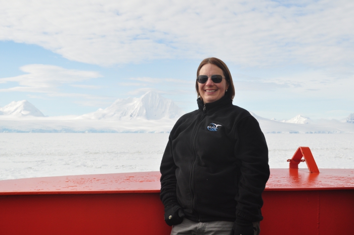 Cara Pekarcik poses in front of the ice-covered mountains of Anvers Island, Antarctica, aboard the Nathaniel B. Palmer icebreaker. Photo by Cara Pekarcik (PolarTREC 2016), courtesy of ARCUS.