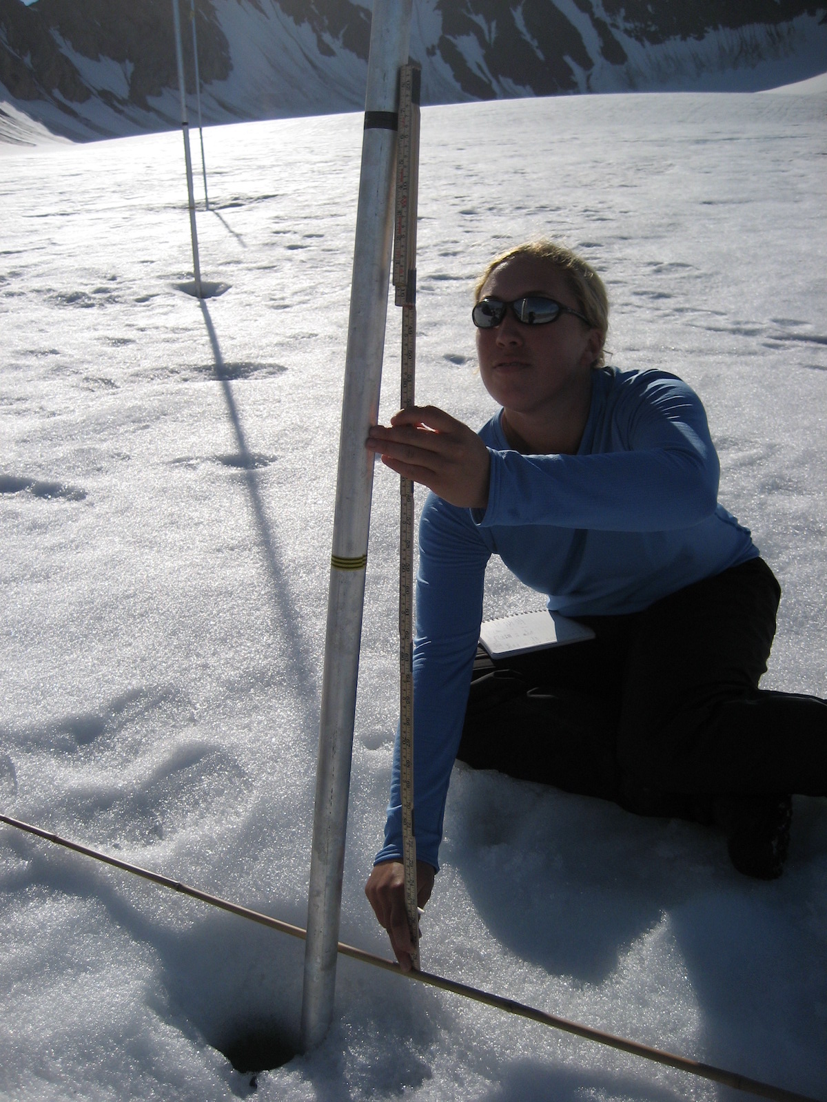 A meter stick is used to measure changes in glacial ablation (snow loss and ice melt). Note the yellow tape on the pole. This was the depth of the snow and ice on July 23, 2008. At Linne Glacier in Linne Valley, Svalbard, Norway.