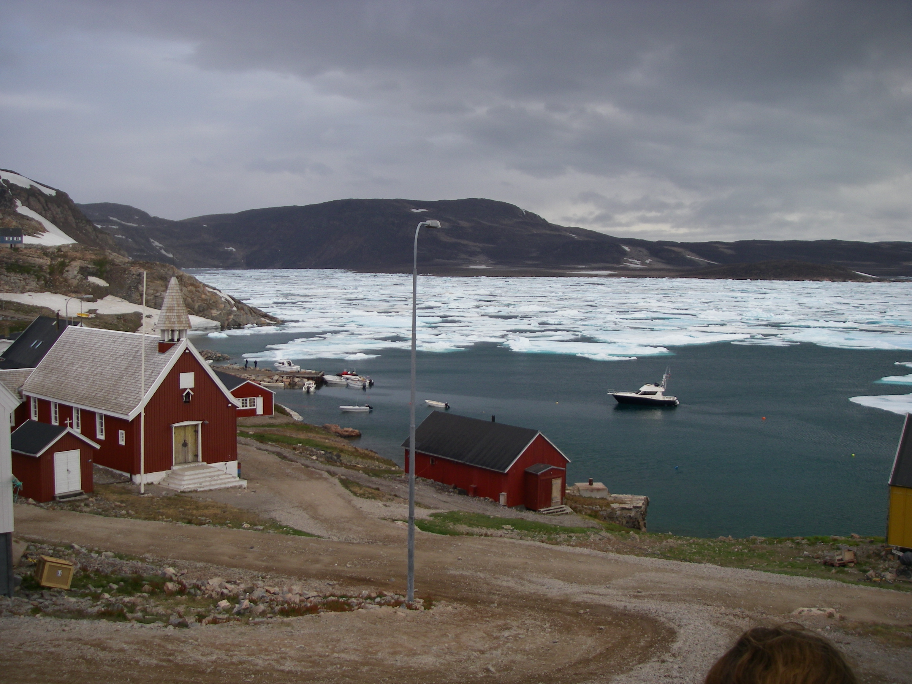 The community church is found adjacent to the bay at Ittoqqortoormiit, Greenland.