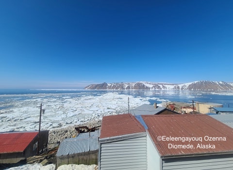 View from Diomede looking toward Big Diomede Island. The ice at the beach an up north is all from Russia side.