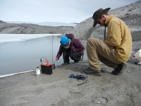 Figure 1. Ben Linhoff (right) and Jemma Wadham collecting groundwater samples for later chemical analysis at the terminus of the Leverett Glacier. Photo courtesy of Matt Charette, WHOI.