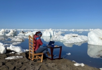 Figure 1. Principal Investigator Jessie Creamean prepares for a podcast interview in Utqiaġvik. Creamean's research is part of a multi-year effort to determine whether ice nucleating particles (INPs) from permafrost make their way into the Arctic atmosphere via lateral hydrologic transport. To do this, her team collects samples along coastal water, lakes, and the Elson Lagoon. Photo courtesy of Thomas Hill.