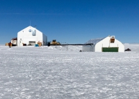 A new mobile garage (on left) has been constructed at Summit Station. The garage sits on a mobile sled-like base that allows the garage to be periodically towed into a new position to combat surrounding snow accumulation and drift. The old garage (on right) sits below the horizon and will be deconstructed and removed from station beginning in 2018. Photo courtesy of Jennifer Mercer.