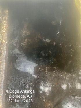 Thawed ice cellar in Diomede, AK on 22 June 2023. Photo courtesy of Odge Ahkinga.