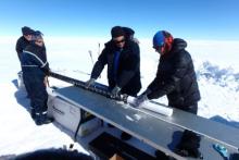 Researcher Eric Wagner and PolarTREC teacher Steve Kirsche receive the core sample from the drill. Core sample