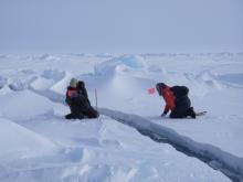 Cathy Geiger and Nick Hughes set up a station to measure the width of the lead. At the SEDNA/APLIS Ice Camp north of Prudhoe Bay, Alaska.
