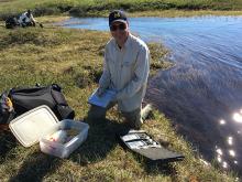 Dr. George Kling taking lake samples. Photo by DJ Kast