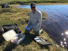 Dr. George Kling taking lake samples. Photo by DJ Kast Dr. George Kling taking lake samples. Photo by DJ Kast