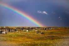 Figure 1. Rainbow over racks of drying seal or “ugruk” meat in Nigiitchiak, Alaska. Photo courtesy of Dennis Davis, all rights reserved, do not reprint without permission.