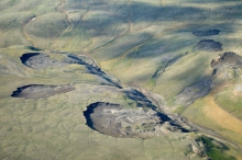 Figure 1. Active retrogressive thaw slumps (RTS) in Aulavik National Park, northern Banks Island. Most of these RTS were first observed on the Timelapse imagery from 2012. Photo courtesy of Sarah Beattie, Parks Canada.