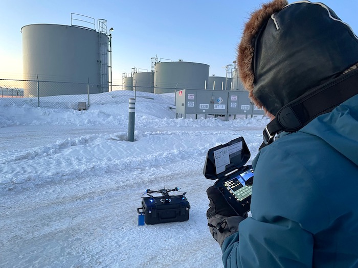 Figure 3. Native Village of Unalakleet/Uncrewed Aircraft Systems Pilot K. Daniels preparing to perform infrastructure inspection flight of the UNK bulk fuel storage facility. Photo courtesy of J. Garron.