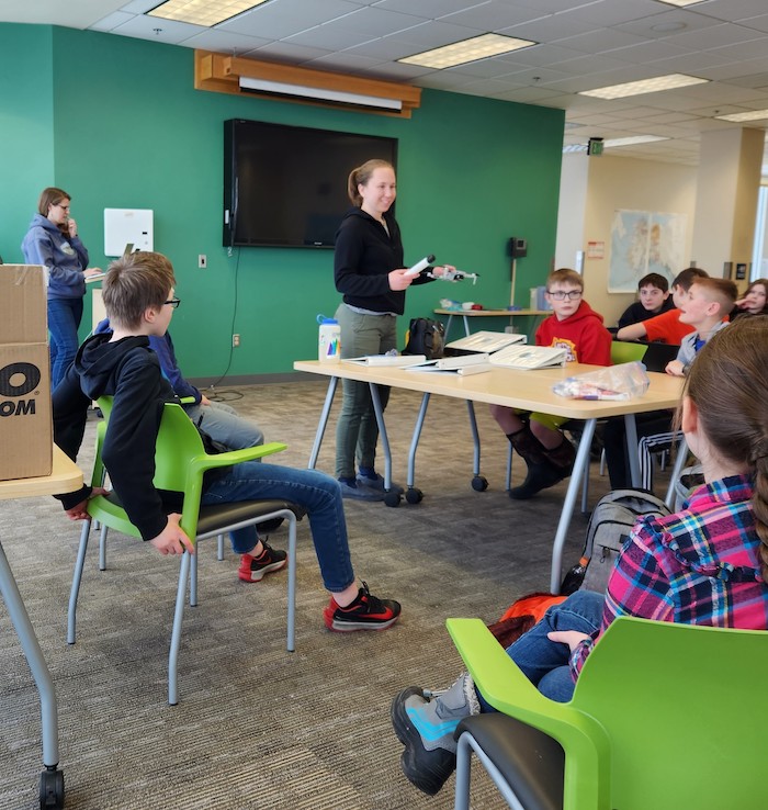 Figure 3.Team members Emily Eidam (left) and Sarah Clement (center) help students from Fairbanks CyberLYNX start thinking about how to measure river sediment with optical backscatter sensor (OBS) sensors and drones. Photo courtesy of Chris Arp.