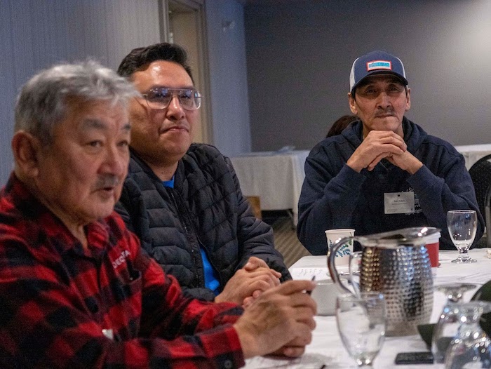 Figure 4. Indigenous participants Stan Ruben, Kirt Ruben, and Lennie Emaghok (left to right) from the Inuvialuit region of northwest Canada listen to discussions at a 2022 meeting of the Arctic Beaver Observation Network in Yellowknife, Canada. Photo courtesy of Ken Tape.