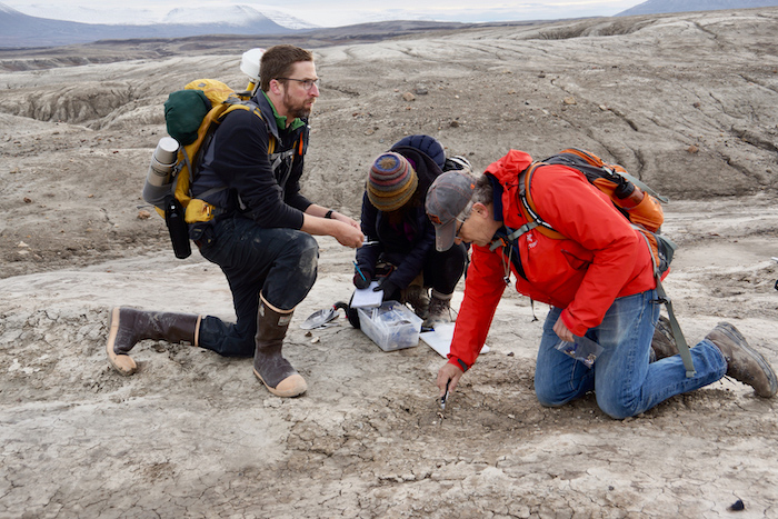 Figure 6. Brendan Reilly, Anna Glüder, and Alan Mix bagging clams shells on Wulff Land, Greenland. Image courtesy of John Farrell, USARC.