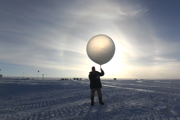 Steve Kirsche prepares to launch a radiosonde (weather balloon) at Summit Station, Greenland. Photo by Heather McIntyre, Courtesy of Steve Kirsche (PolarTREC 2017), Courtesy of ARCUS.
