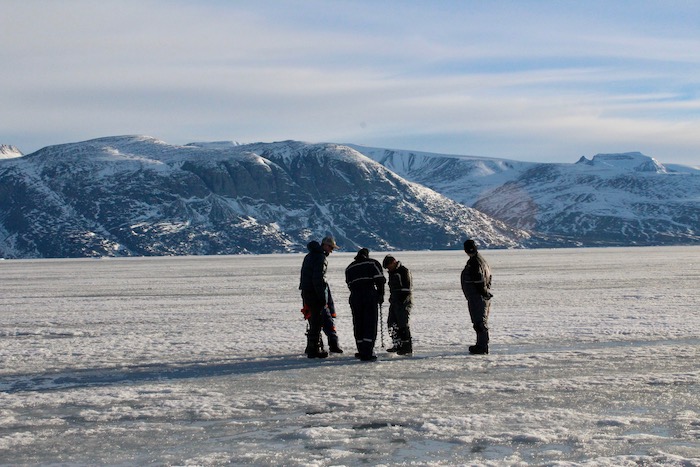 Figure 4. Measuring sea ice thickness with an ice drill. Photo courtesy of Sarah Cooley.