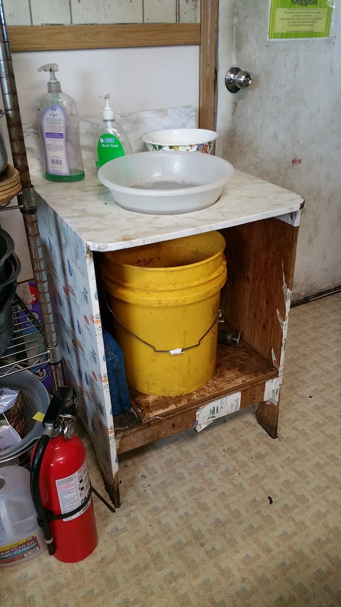 Figure 3: Hand washing basin in Kongiganak, Alaska where there is no indoor plumbing.  Currently the community is working to find an engineering solution to provide sustainable indoor plumbing.  Photo courtesy of Jennifer Schmidt.