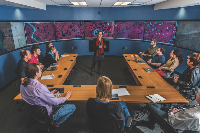 Alaska NSF EPSCoR Project Director, Pips Veazey, speaks inside the Vis Space visualization and collaboration environment. Photo courtesy of Todd Paris/UAF.